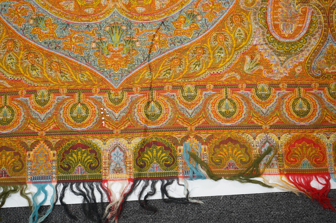 A French possibly Lyon, 19th century ornate silk and fine wool woven Paisley patterned shawl. Woven in polychromes coloured silks and wools on a jacquard loom, using an array of punch cards to create this elaborate desig
